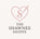 Logo of The Shawnee Shoppe with a heart and 'S' design on a light pink background